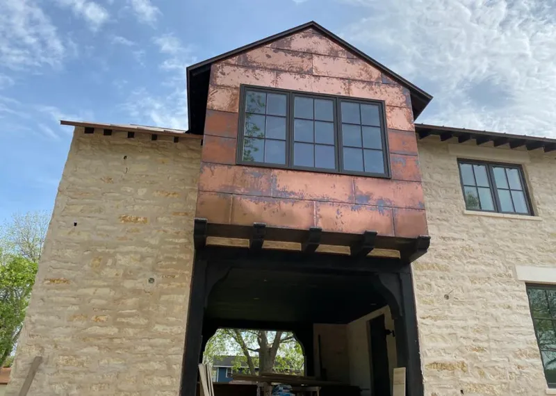 Copper metal panel facade on a stone building for Skylight Installation in Big Bear City