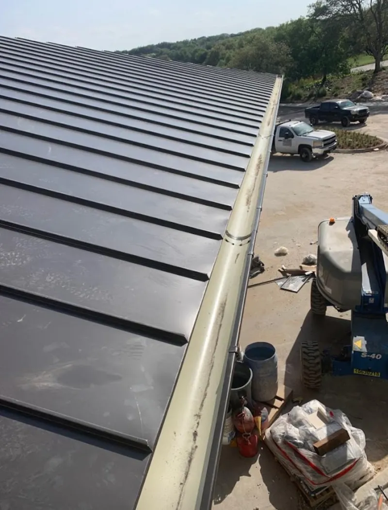 Standing seam panel and gutter detail on a metal roofing jobsite in Big Bear City